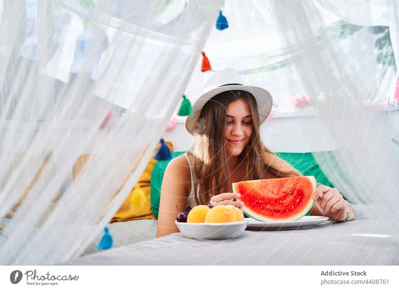 Cheerful woman with fresh watermelon sweet summer ripe young tasty backyard tent female smile cheerful happy eat enjoy delicious positive healthy organic