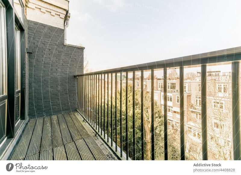 Terrace with metal railings on sunny day balcony apartment building terrace construction modern design style dwell district neighborhood daytime facade
