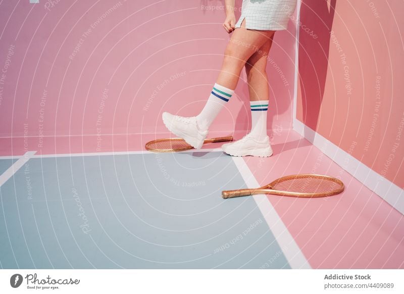 Crop player in sneakers with racket on tennis court sport style knee sock walk woman sportswoman ball creative design modern ornament stroll sportswear