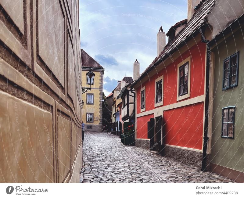 A small street with a small colorful houses, red yellow and green, the old town of Prague, Czech Republic home prague czech republic red house Lantern Sky Blue