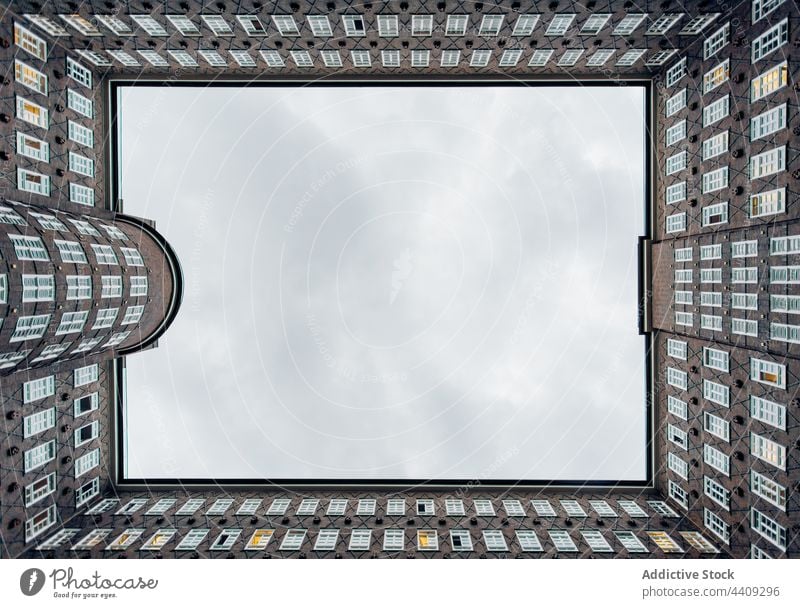 Facade of office building against cloudy sky symmetry window facade architecture construction urban exterior style chilehaus hamburg germany design contemporary
