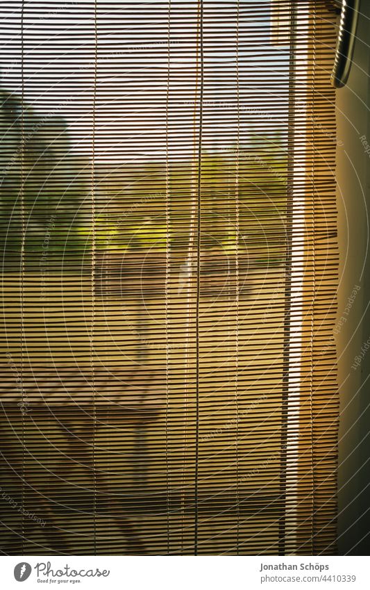 View from the apartment through bamboo blind on the balcony door outlook Roller blind Window French windows Balcony Table sunny inboard dwell Flat (apartment)