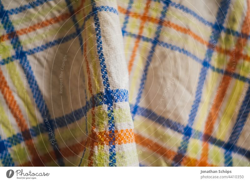 Checkered tea towel or kitchen towel Tea towel Rag Wipe Towel Blanket Cloth Textiles Pattern White Blue Orange Yellow crease Interior shot Structures and shapes