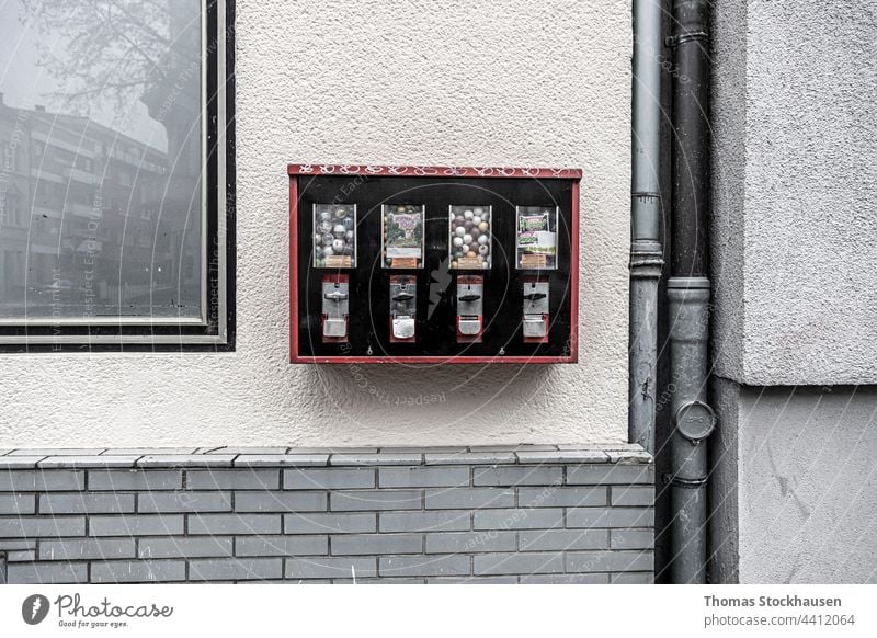 gum ball machine fixed on a wall, sewage pipe and reflections in window antique architecture automat automated automation background bubble bubblegum building