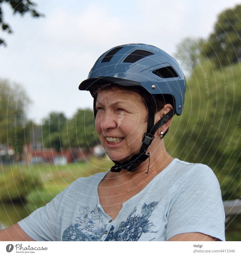 Portrait of a laughing woman with bicycle helmet on her head Human being Woman portrait Head Face Bike helmet Cycling kind Smiling Laughter Protection Headwear