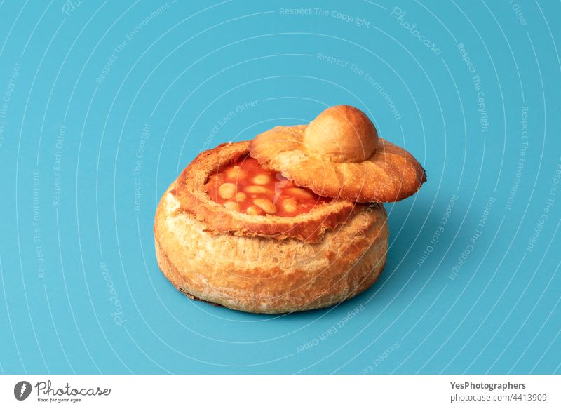 Baked beans in a bread bowl isolated on a blue background. baked baked beans boiled breakfast british cooked copy space crust cuisine cut out delicious dish