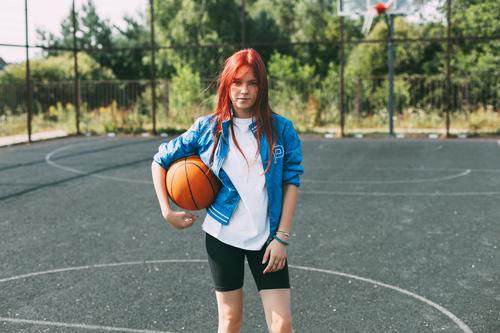 Portrait of a smiling teenage girl with a basketball on the sports field. Sports, health, lifestyle playground holding portrait player active activity leisure