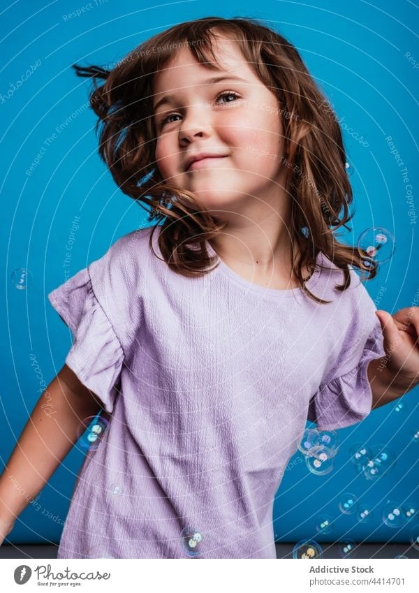 Cheerful preteen girl dancing in studio with soap bubbles dance child carefree smile move freedom having fun kid cheerful joy bright enjoy creative fly float