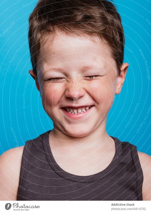 Cute child with closed eyes in studio eyes closed content kid boy cheerful childhood happy smile adorable cute carefree playful innocent optimist glad fun joy