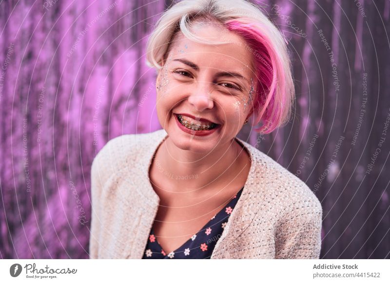 Informal woman with dyed hair on purple background in city informal smile appearance style urban trendy braces subculture female outfit street modern