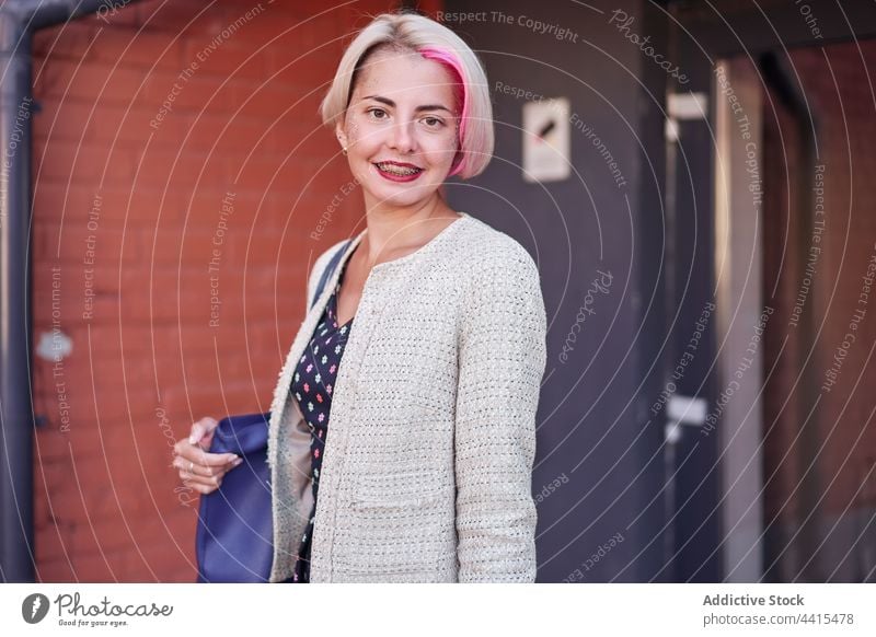 Content informal woman in city street alternative dyed hair smile urban content appearance subculture female short hair individuality style hairstyle optimist