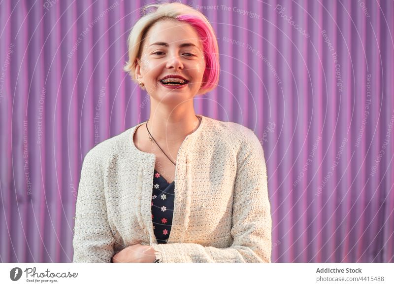 Informal woman with dyed hair on purple background in city informal smile appearance style urban trendy subculture female outfit street modern individuality