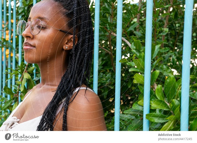 Serene black woman with braids in park serene summer tranquil enjoy carefree nature hairstyle female ethnic african american barceloneta barcelona spain calm