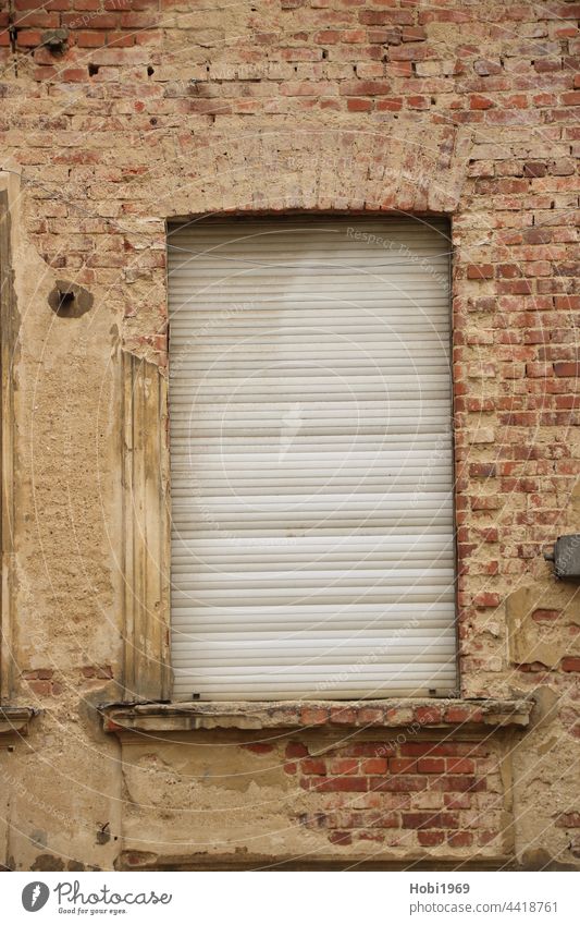 Closed roller shutter on a window in a brick facade Roller shutter Window Wall (building) Brick House (Residential Structure) Facade Manmade structures Old