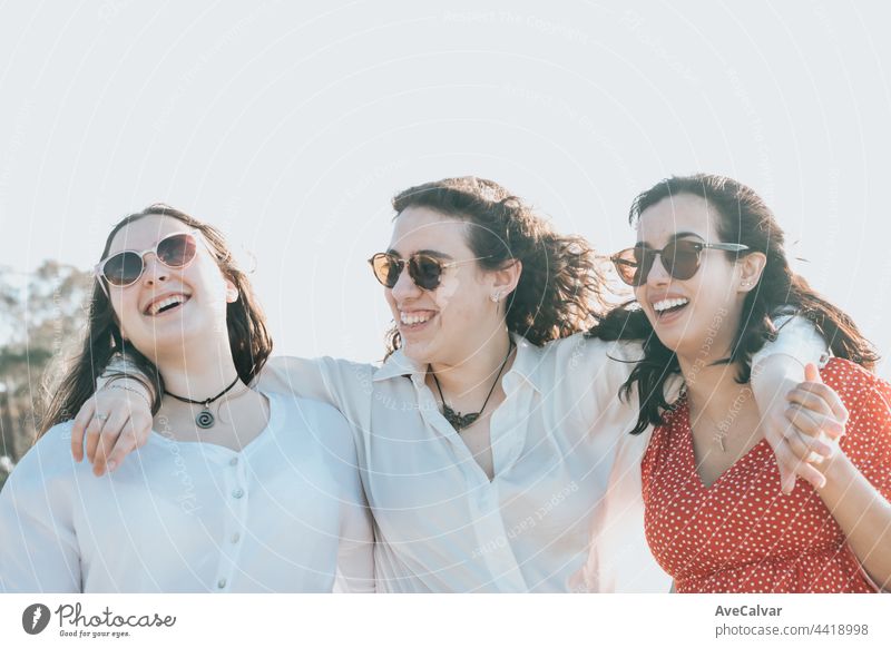 Happy young women laughing and smiling at the beach on a summer day, enjoying vacation, concept of friendship enjoying the outdoor party happiness people group