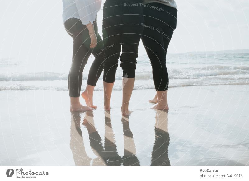 Close up of three women legs on the beach during a sunny day, vacation and relax concept person step teenage sand arena down dusk enjoy ethnic fingers friends