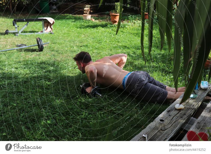 young man doing fitness in garden Fitness Fitness training workout Athletic Sports Training Lifestyle Healthy Body Force Muscular Practice Strong youthful