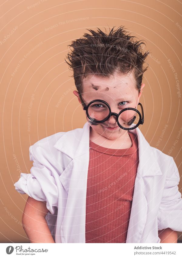 Scientist boy in eyeglasses and laboratory robe scientist shock dirty experiment omg concept portrait crazy mad addict astonish reaction mouth opened