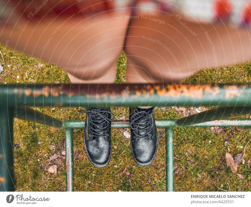 Person with boots on park swing person foot horizontal ankle concentration dressed fancy human jump knee learning men messy photograph run sensual sensuality