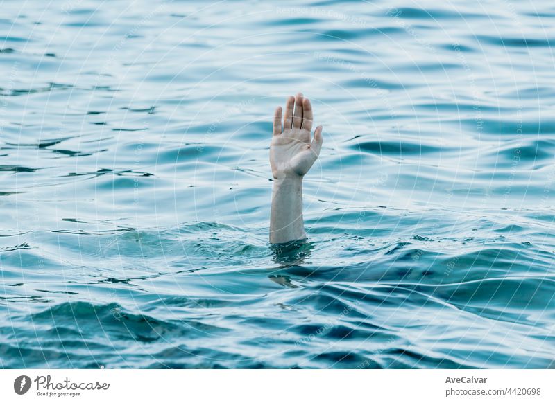 A hand showing out the ocean, rescue and help concept, self care, drown anxiety and problems conceptual image, copy space catching death deep drop emotion