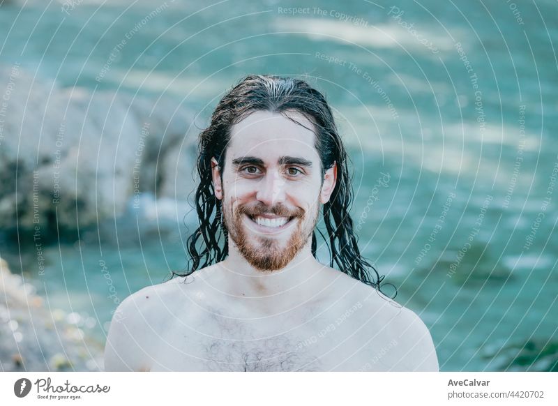 Man with long hair smiling to camera with wet hair, confidence, holiday concept, portrait, shirtless horizontal men one person photography standing young adult