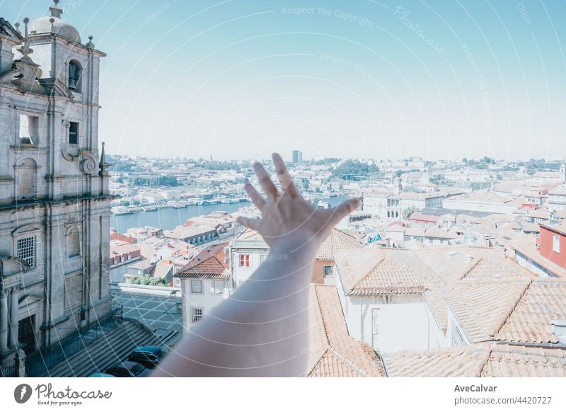 One hand over the city of porto during a super bright day, travel and visit city tourism concept window one person real people young adult caucasian ethnicity