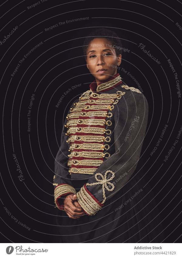 Serious black female in jockey costume in studio woman confident horsewoman portrait stare ponder elegant lonely african american adult individuality