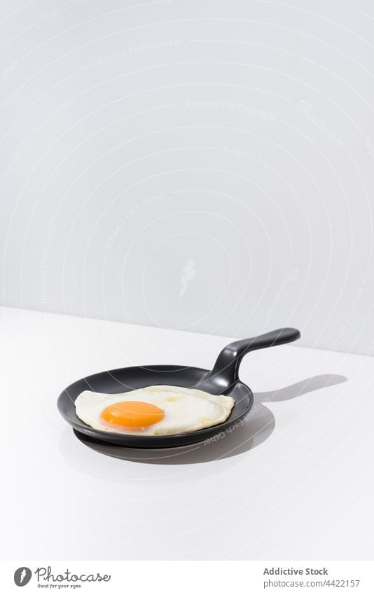 Tasty fried egg on skillet in white table tasty minimal delicious meal food dish cuisine nutrition serve yummy fresh breakfast healthy portion gourmet culinary
