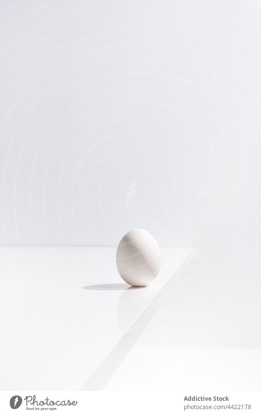 Fresh egg on table in white room fresh color minimal studio natural style food healthy nutrition simple plain desk organic design raw surface easter holiday