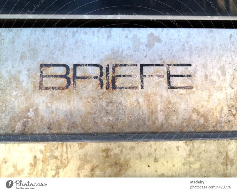 Yellowed inscription BRIEFE in capitals on an old brass letterbox cover at a former bank branch in Oerlinghausen near Bielefeld in the Teutoburg Forest of East Westphalia-Lippe