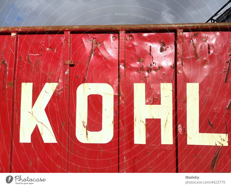 Large red waste container with the inscription KOHL in the sunshine at a recycling yard in Bielefeld in Ostwestfalen-Lippe, Germany Container garbage container