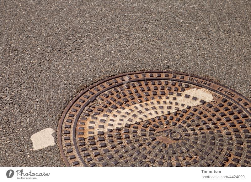 Danish manhole cover Manhole cover Metal Heavy Street Asphalt nap color strip Rust Deserted Exterior shot din norm