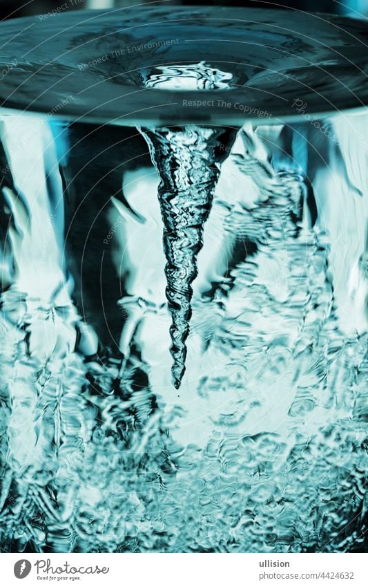 Water vortex in glass tube, tornado, storm in water glass with rotating air column, water tube with blue vortex vertebra Aerodynamics Spin Wellness freshness