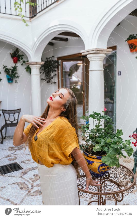 Trendy woman standing in patio grace trendy style house charming enjoy summer romantic female table bloom plant flower blossom flora yard harmony cottage tender