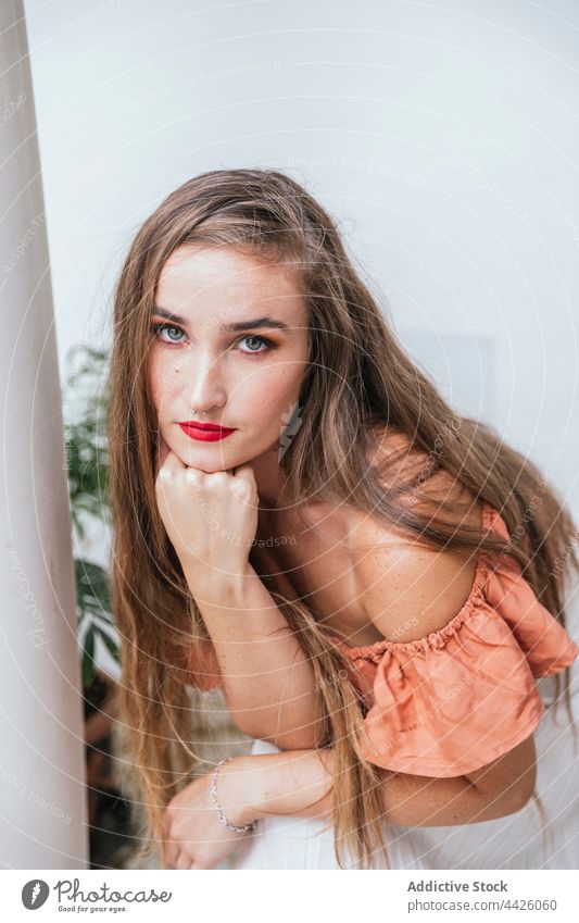 Graceful woman with red lips in patio grace long hair appearance charming complexion serene summer female peaceful chill style enjoy content gorgeous dreamy