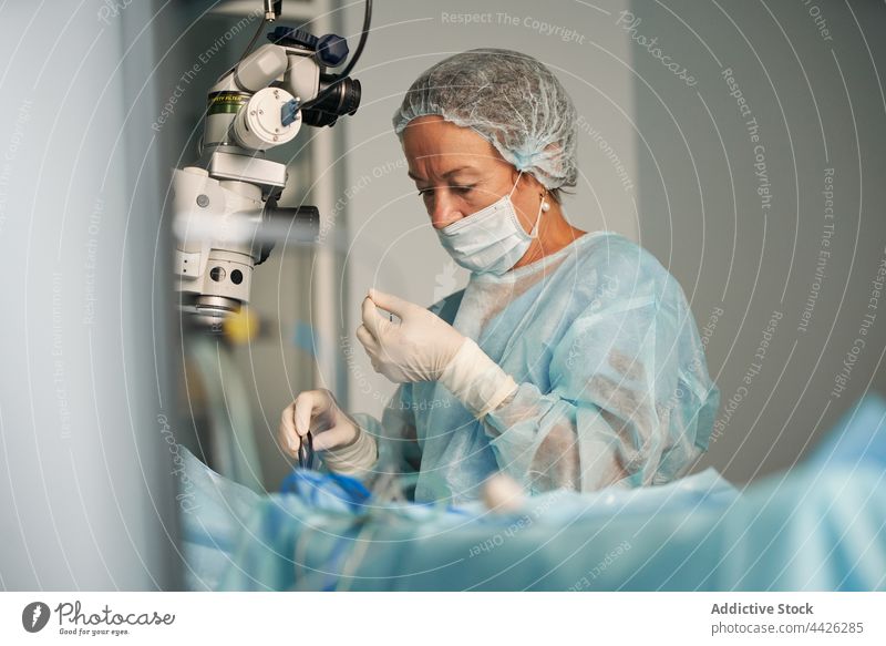 Surgeon in medical uniform working in operating room woman surgeon mask profession portrait specialist sterile nurse clinic doctor surgical hospital