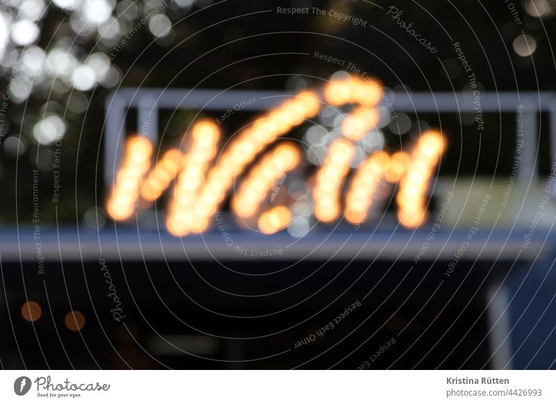 wine lettering in blurred illuminated letters Vine neon sign blurry hazy Blurred bokeh clearer Illuminate Letters (alphabet) writing Text light bulbs