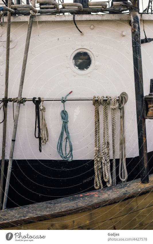 knotted ropes on a metal pipe on a fishing boat Steel Fishing boat Porthole Knot Navigation Fishing port Exterior shot Colour photo Harbour Day Deserted