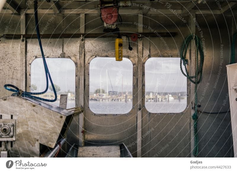 View through the window of a fishing boat on the water and sailing boats Fishing boat Vantage point Sailboat Water Sky Exterior shot Colour photo Ocean