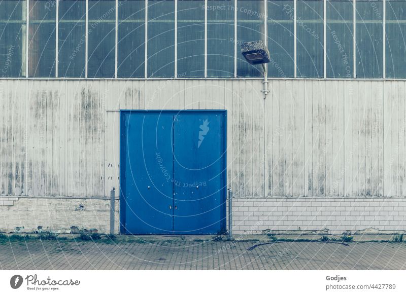 Facade of a factory building with blue gate and lighting Goal Blue Lamp Lighting Factory hall Architecture Building Wall (building)