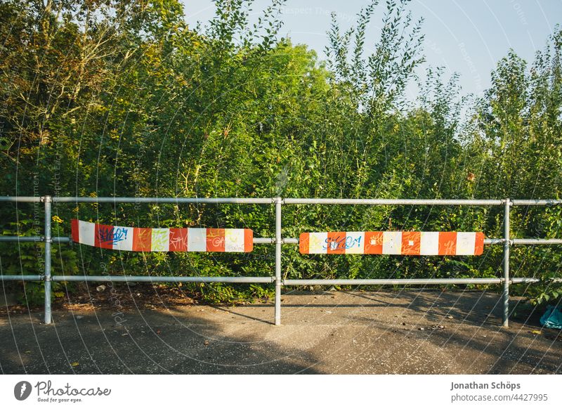 dead end street end fence barrier in front of nature No through road End of road Fence cordon Nature Footpath Red White rail ending bushes trees Environment