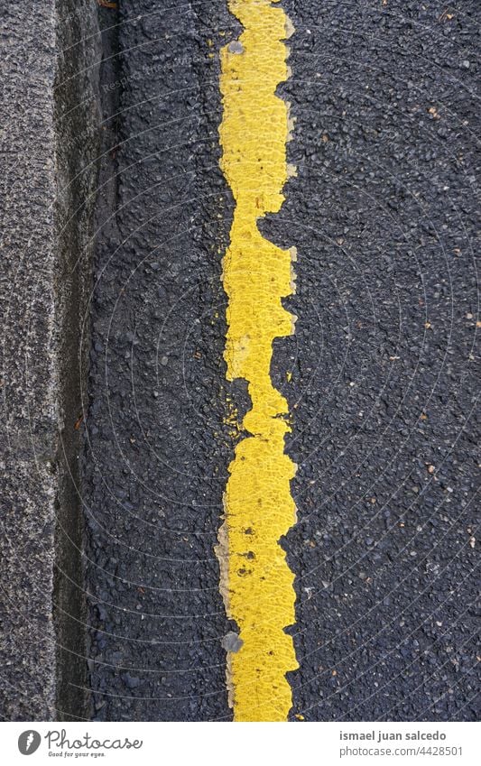 yellow line on the asphalt road ground textured abstract backgrounds old surface pattern