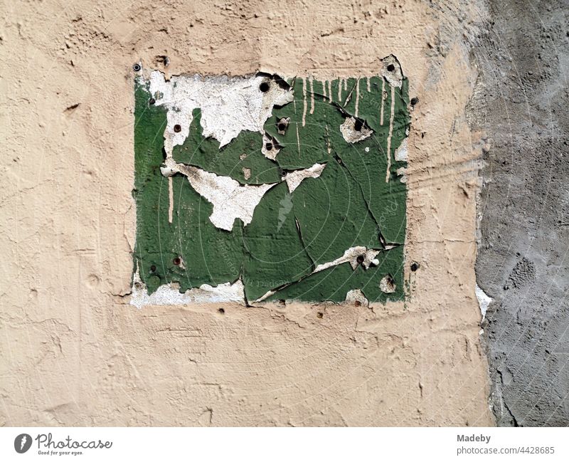 Remnants of various layers of paint on the roughcast of a run-down facade in Oerlinghausen near Bielefeld on Hermannsweg in the Teutoburg Forest in East Westphalia-Lippe