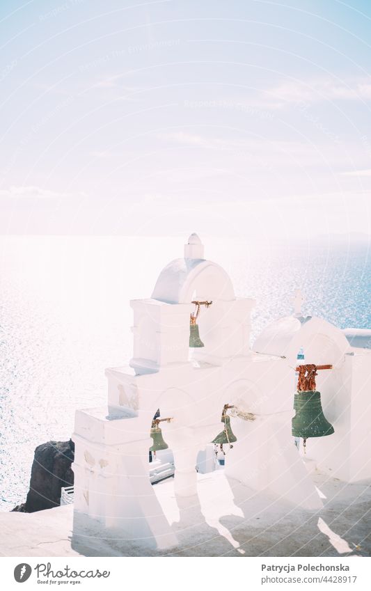 White bells by the sea in Santorini in a bright sunlight Church bell Bright Island Greece Mediterranean Sea