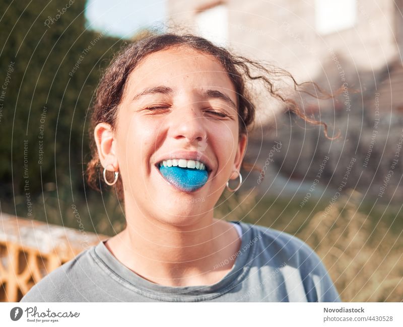 Teenage girl with her blue colored tongue out Girl Child Joy Playground Exterior shot Playing Human being Happy Lifestyle Playful Caucasian Portrait photograph