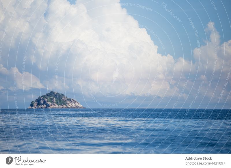 Rippling sea with rocky hill on horizon blue nature environment water island ripple seascape scenic blue sky stone cloudy clear endless geology formation rough
