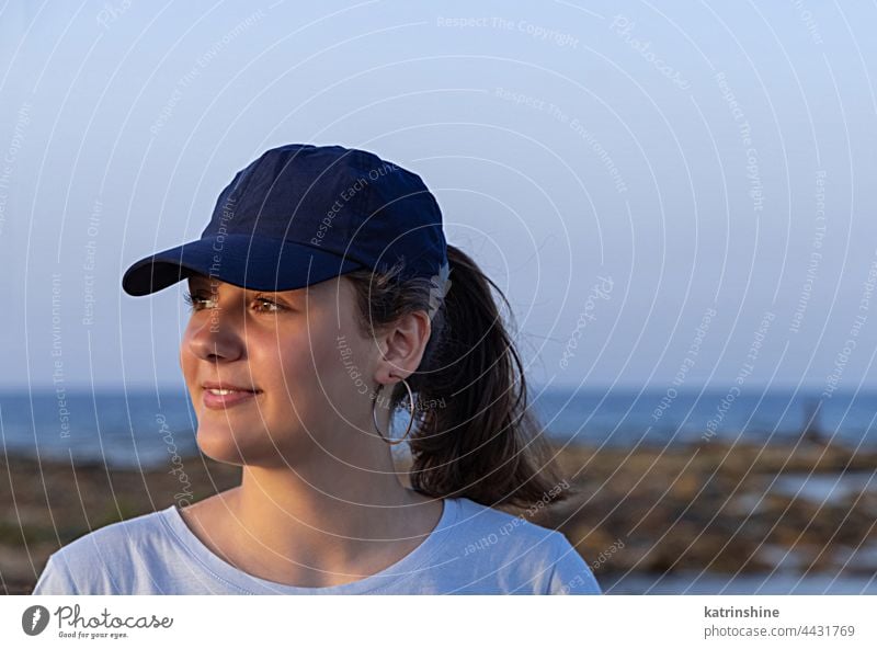 Teen girl in dark blue baseball cap at sunset outdoor teenager adolescent Caucasian mockup visor look aside head wearing teen girl childhood female happiness