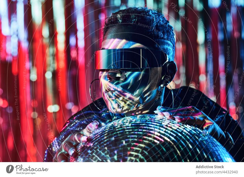 Cool black model in futuristic glasses with glitter ball fashion cyberpunk style cool woman disco wristwatch accessory 80s 70s creative design individuality