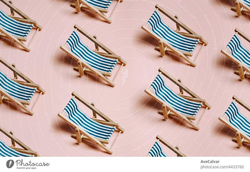 Pattern of summer beach chairs over a pastel pink background with copy space, minimalism, summer and relax concept, networks abstract sun journey art fun