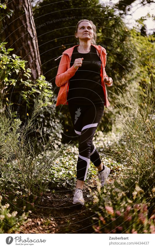 Sporty woman jogging in the forest Athletic Woman Nature Healthy workout Lifestyle Fitness Jogging Walking Sports Back-light Orange Sun Heathland pretty